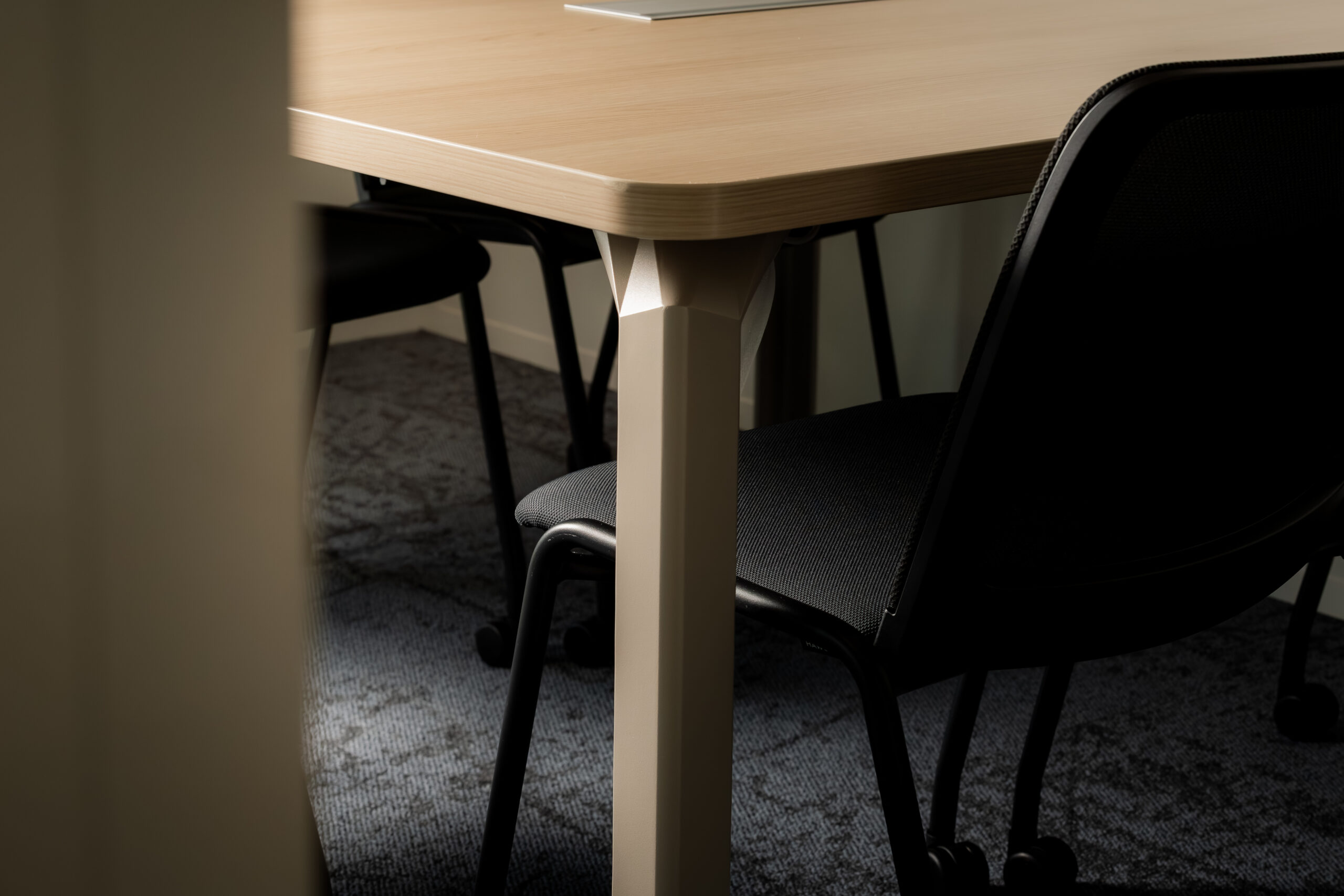 Détail mobilier design — plateau de table et piètement en gros plan